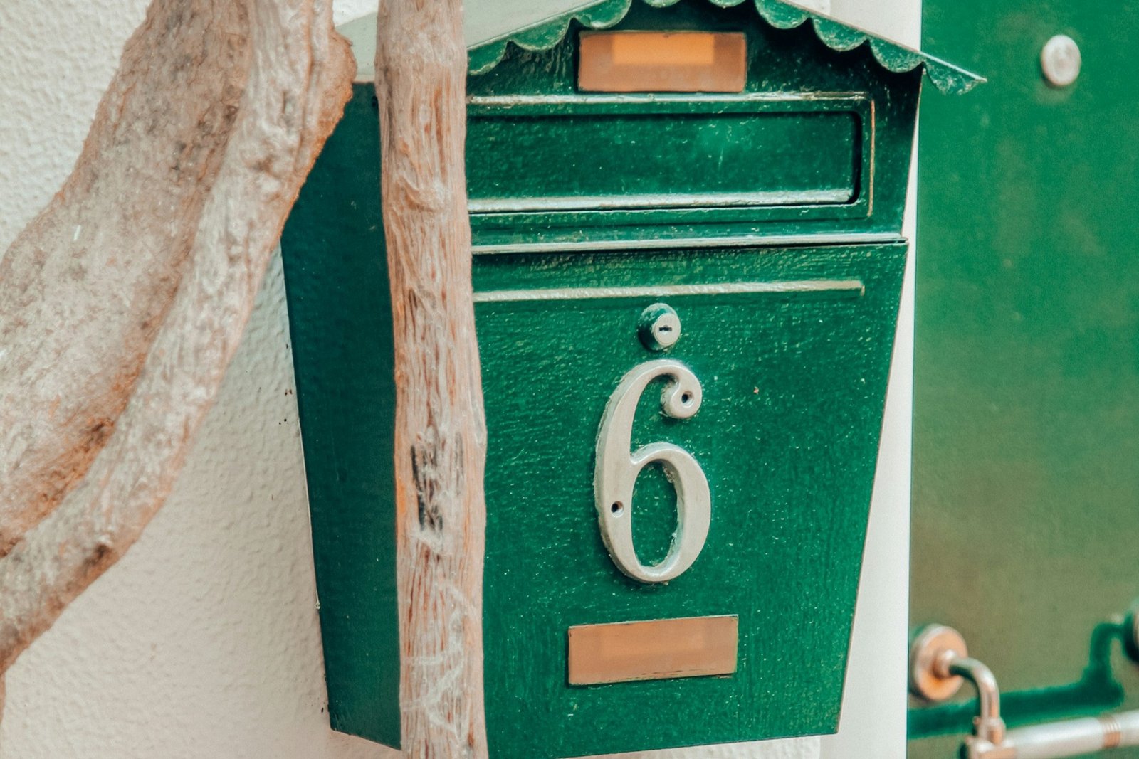 Hand hält kleine Flasche mit Graphitpulver neben einem Türschloss